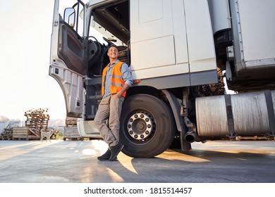 Driver standing near opened truck's cap