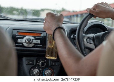 A driver steers with one hand while holding a drink in the other, demonstrating multitasking.