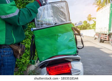 The Driver Takes The Food Out Of The Box For Delivery To The Customer At Home From Online Ordering.