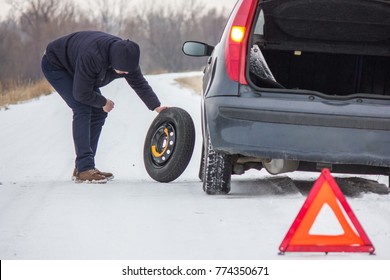 Driver Took Spare Tire To Change A Flat One On Winter Road