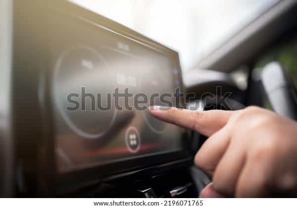 Driver touch\
car touchscreen to access application for automotive device. Finger\
pointing on screen for interior automobile technology for\
navigation, communication and\
entertainment.