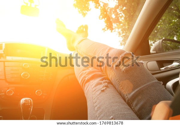 Driver training car on road in summer sunny day.\
Happy young woman inside vehicle driving. Vacation ride trip travel\
concept.