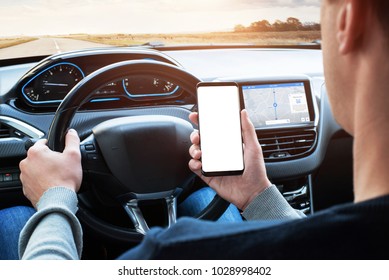 Driver use smart phone while driving. Isoalted screen for app promotion. Modern car interior with car board display with navigation. - Powered by Shutterstock
