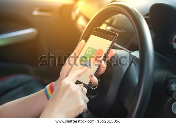 The driver is using Google Maps to find places\
and routes for traveling during the holidays on November 16, 2019\
in Chiang Rai, Thailand.
