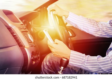 Driver using mobile phone :hand using phone sending a text or find locations and get directions with Maps while driving to work businessman or travel