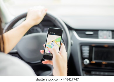 Driver Using Navigation App On Mobile Phone