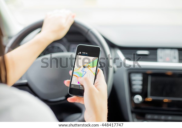 Driver using\
navigation app on mobile\
phone