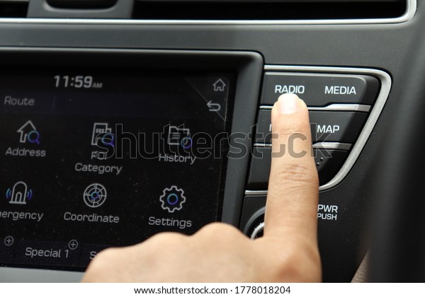 Driver using radio\
system while driving\
car.