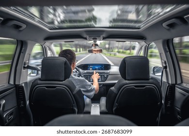 Driver using touch screen in car. Digital road trip.