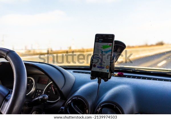 Driver using Waze maps app\
for showing the right route through the traffic in Bucharest,\
Romania, 2022