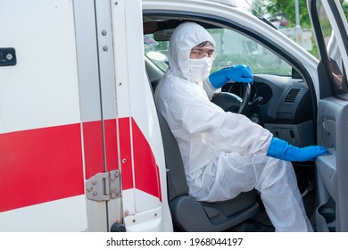 Driver Wear PPE In Front Of The Ambulance With Protective Suit, Mask Gloves At Ambulance Car Vehicle For Helping The Patient Of Coronavirus Or Covid-19 