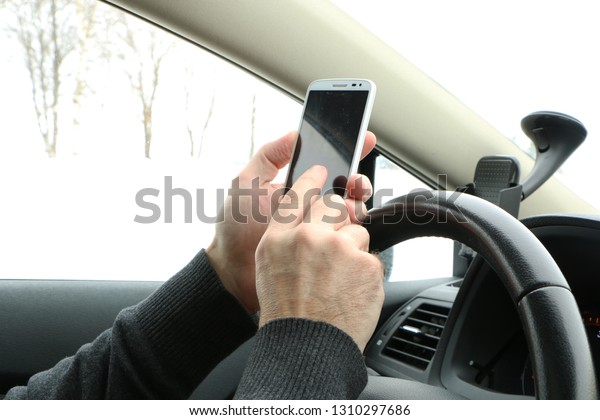 the driver at the wheel drinks coffee, eats the\
hot dock and talks on the\
phone