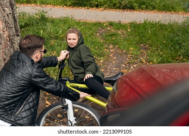 Driver While Parking Knocked Down Woman On Bicycle Crash Car Accident. Man Helps Girl To Get Up After Fall.