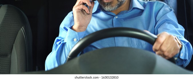 A Driver Who Does Not Comply With Traffic Rules And Safety Driving. Conceptual Image. The Man Is Talking On The Phone And Is Not Wearing A Seat Belt.