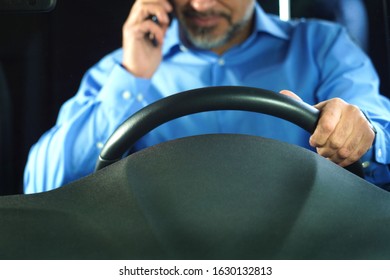 A Driver Who Does Not Comply With Traffic Rules And Safety Driving. Conceptual Image. The Man Is Talking On The Phone And Is Not Wearing A Seat Belt.