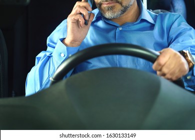 A Driver Who Does Not Comply With Traffic Rules And Safety Driving. Conceptual Image. The Man Is Talking On The Phone And Is Not Wearing A Seat Belt.