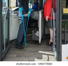 driver, woman and man with limited mobility taking a bus at a bus stop. no face.  handicapped or physically challenged young male  wait for bus in a station - Powered by Shutterstock