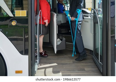 driver, woman and man with limited mobility taking a bus at a bus stop. no face.  handicapped or physically challenged young male  wait for bus in a station - Powered by Shutterstock