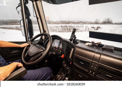 A Driver At The Workplace Driving A Truck. Inside View Of The Cab