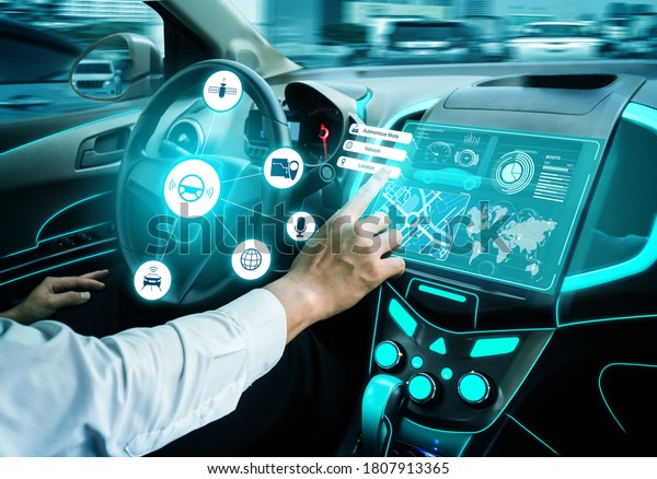 Driverless car interior with futuristic dashboard for
autonomous control system . Inside view of cockpit HUD technology
using AI artificial intelligence sensor to drive car without people
driver .