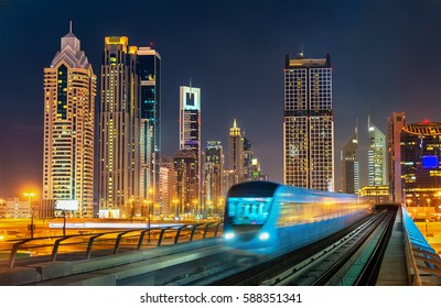 Driverless metro train with skyscrapers in the background - Dubai, the United Arab Emirates.