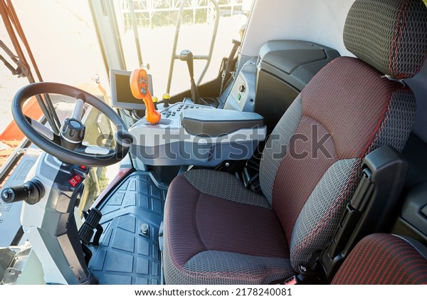 The driver\'s cabin in a modern harvester for\
working on an agricultural\
field.
