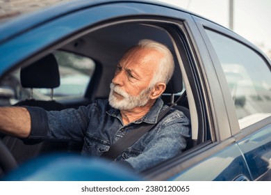 Driver's face contorted in rage as somebody offends him in the traffic.