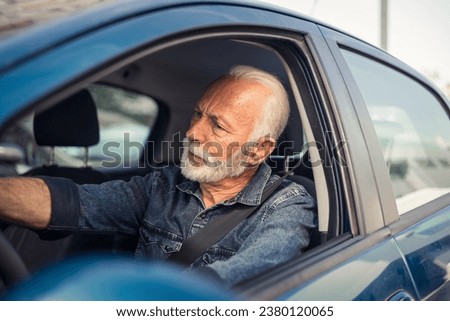 Driver's face contorted in rage as somebody offends him in the traffic.