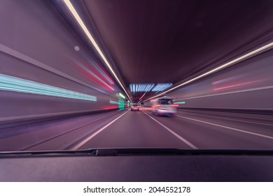 Drivers Front View, Driving Fast In A Tunnel By Var With Lots Of Blurry Lights, Concept For Highspeed With A Eyecatching Violet Tint.