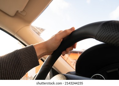 Driver's Hand On The Steering Wheel Inside Of A Car On Road, A Man Driving A Car In City Rush Hour Traffic Congestion Discomfort Drive At Low-speed Morning Sun View.