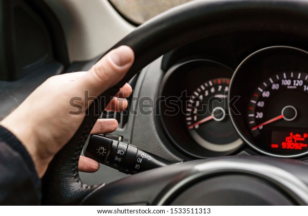 Driver\'s hand\
on steering wheel turns on turn\
signal