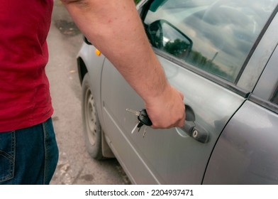 The Driver's Hand Presses The Keychain From The Car Alarm. The Driver Disables The Car Lock..