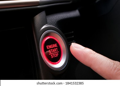 The driver's hand is pressing the car start button. Concept of transportation and technology - Powered by Shutterstock