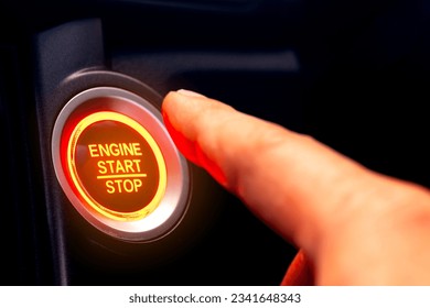 The driver's hand is pressing the car start button. Concept of transportation and technology - Shutterstock ID 2341648343