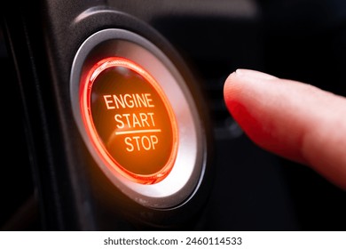 The driver's hand is pressing the car start button. Concept of transportation and technology - Powered by Shutterstock