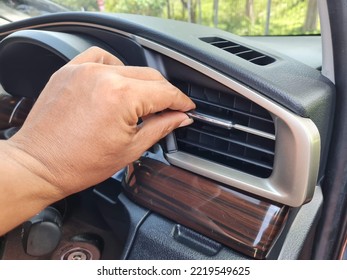 The Driver's Hand Regulates The Direction Of Air Flow From The Car Ac Vent When The Temperature Is Hot While Driving