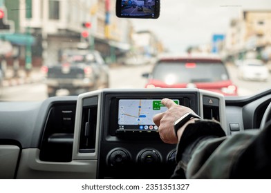 Driver's Hand Using GPS Screen or map During Road Trip, Dangers Of Using Technology While Driving