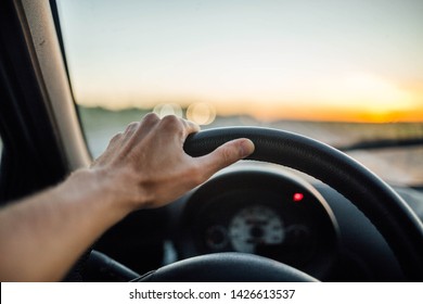 driver's hands driving a car on a hot sunny day. trip to nature outside the city. - Shutterstock ID 1426613537