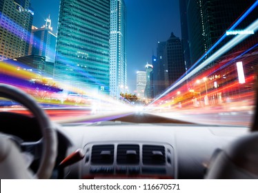 Driver's Hands On A Steering Wheel Of A Car And Night Scene