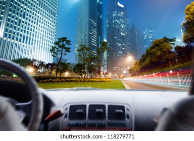 Driver's Hands On A Steering Wheel Of A Car And Night Scene