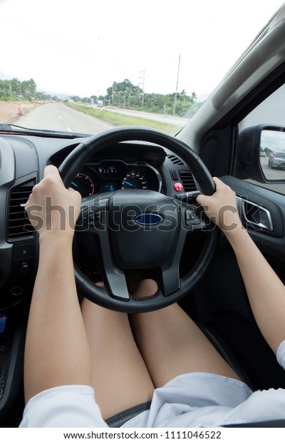 Driver\'s\
hands on a steering wheel of a car and\
Drizzle