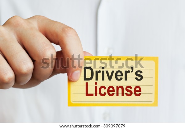 Drivers License. Man holding a card with a message\
text written on it