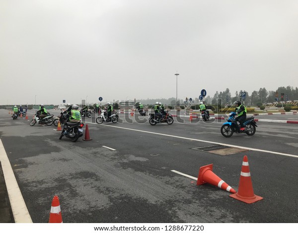 At driver\'s license school, Vinh Phuc\
province, Vietnam - January 11, 2019: A1-level students are\
practicing driving\
motorbikes