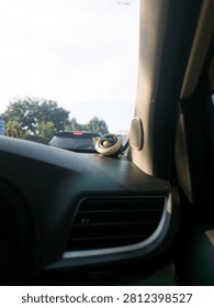 A driver's perspective from inside a vehicle showcasing a custom dashboard audio tweeter and AC vent. The windshield reveals blurred daytime traffic, perfectly capturing the atmosphere of a daily urban commute and automotive lifestyle