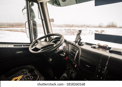 The driver's seat in the cab of the truck, inside view