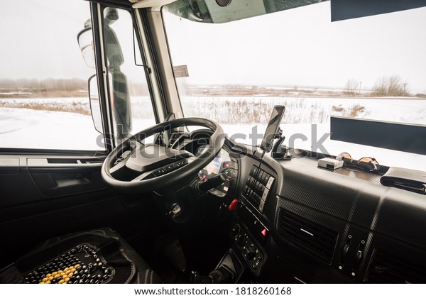 The\
driver\'s seat in the cab of the truck, inside\
view
