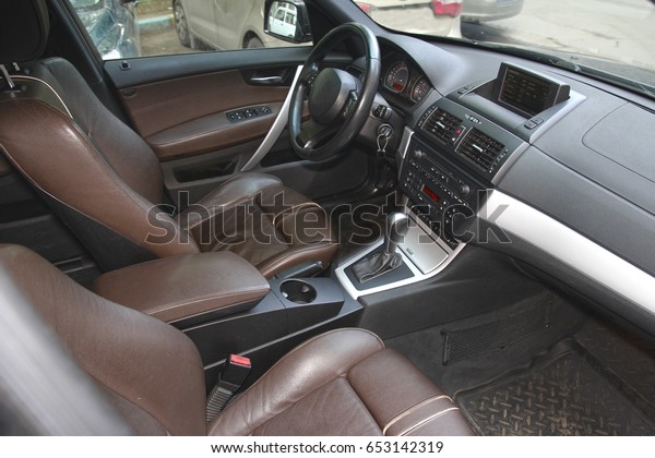 Driver\'s seat in\
the car with a brown\
interior