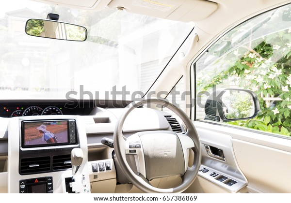 driver\'s seat and the car control panel, steering\
wheel and control\
devices