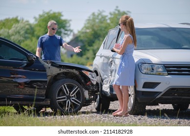 Drivers of smashed vehicles arguing who is guilty in car crash accident on street side. Road safety and insurance concept - Shutterstock ID 2114182928