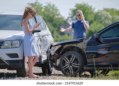 Drivers of smashed vehicles talking on cellphone calling for help in car crash accident on street side. Road safety and insurance concept - Shutterstock ID 2147915629